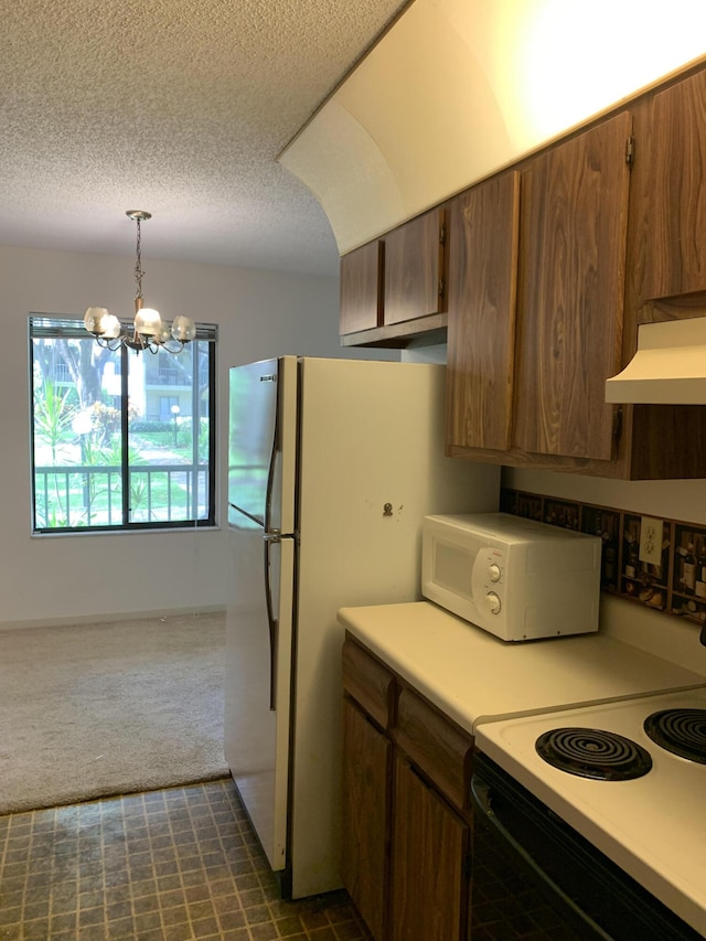 kitchen with white appliances, dark carpet, a chandelier, exhaust hood, and pendant lighting