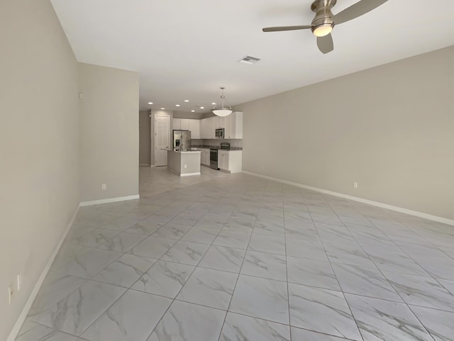 unfurnished living room with ceiling fan