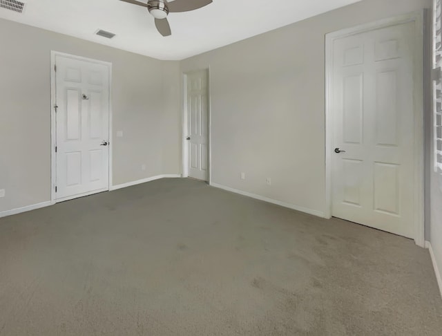 spare room featuring carpet flooring and ceiling fan