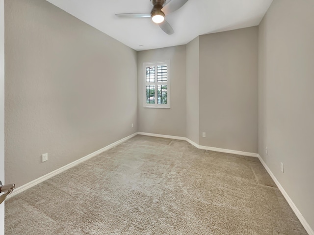 carpeted spare room with ceiling fan