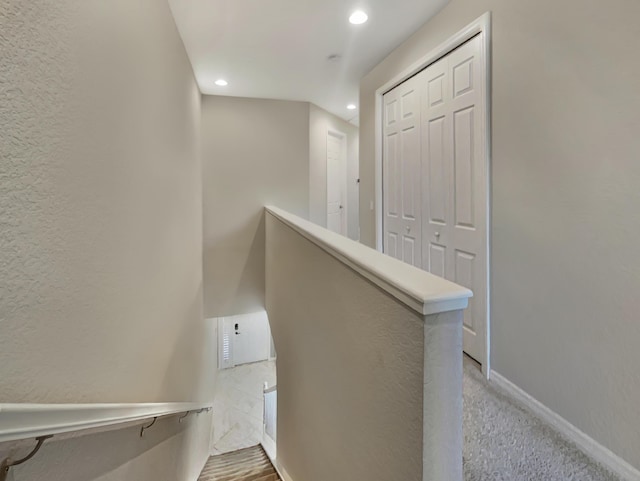 hall featuring light colored carpet