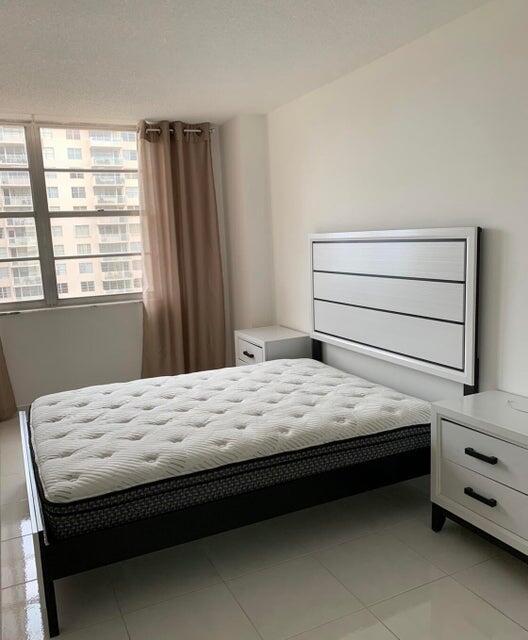 unfurnished bedroom featuring light tile patterned floors