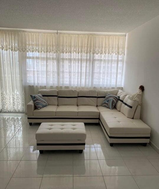 unfurnished living room with light tile patterned floors and a textured ceiling