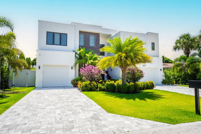 contemporary home with a garage and a front lawn