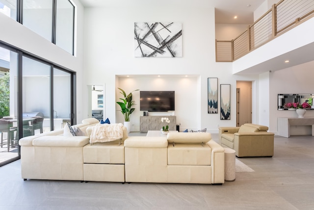 living room featuring a towering ceiling