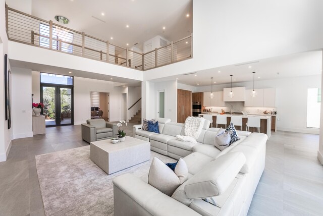 living room featuring french doors and a high ceiling