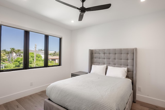 bedroom featuring light hardwood / wood-style flooring and ceiling fan