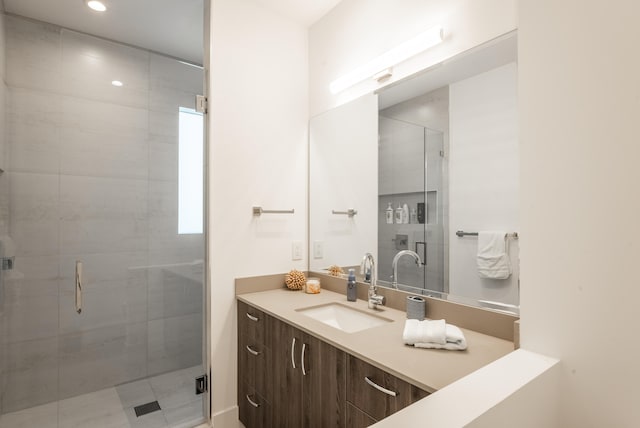 bathroom featuring vanity and an enclosed shower