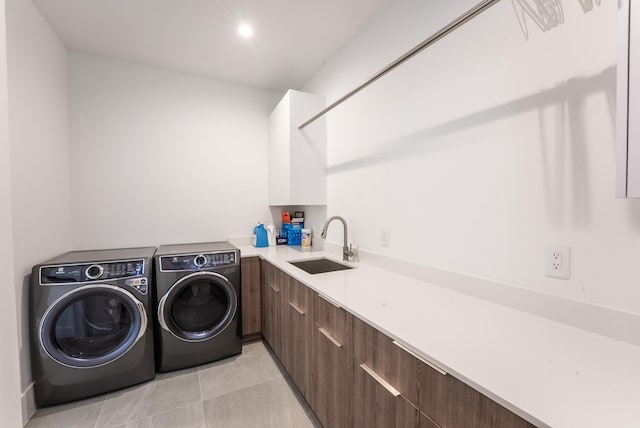 washroom featuring cabinets, light tile patterned floors, independent washer and dryer, and sink