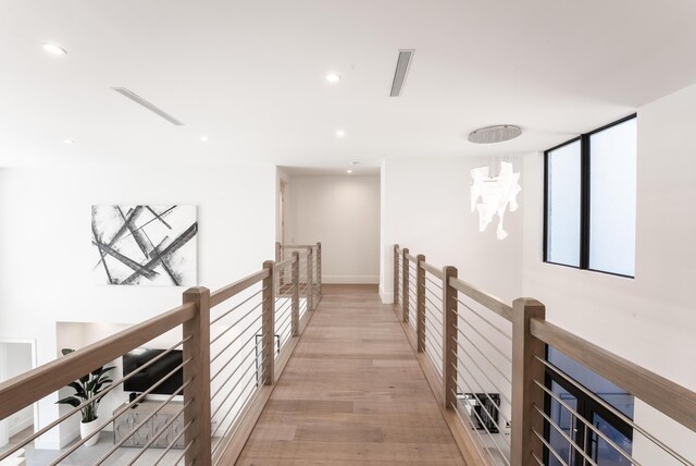 hallway with light hardwood / wood-style flooring