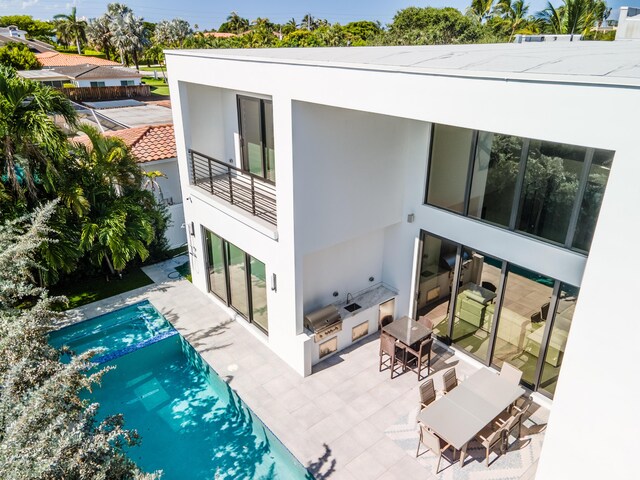 rear view of property featuring area for grilling and a patio