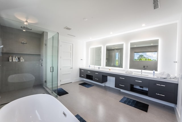 bathroom featuring vanity and independent shower and bath