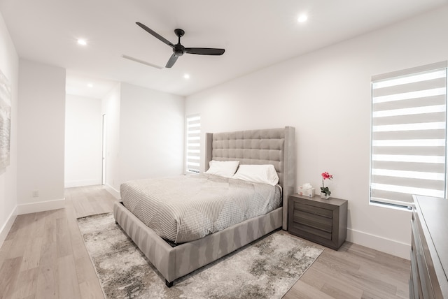 bedroom with ceiling fan and light hardwood / wood-style flooring