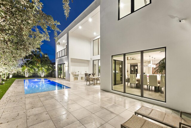 pool at twilight with a patio