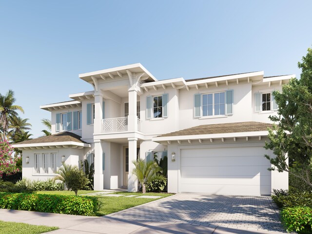 view of front of home with a balcony and a garage