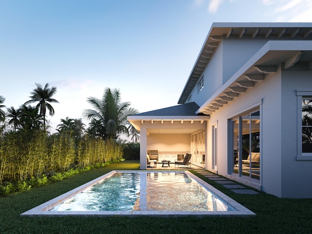 view of pool with a patio and a lawn