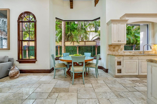 dining room featuring sink and a healthy amount of sunlight