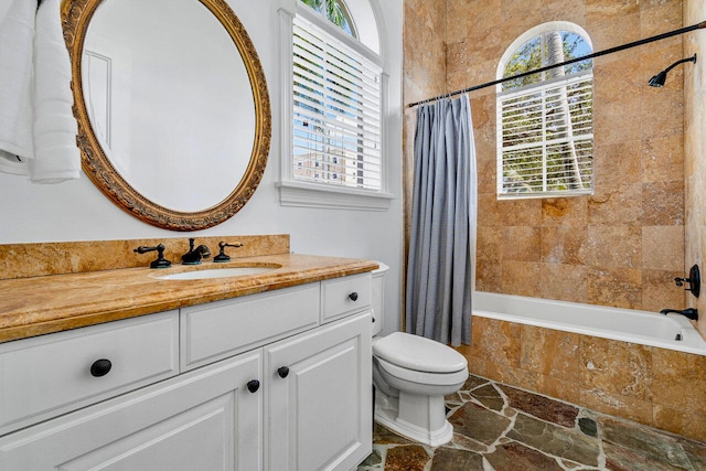 full bathroom featuring shower / tub combo, vanity, toilet, and plenty of natural light