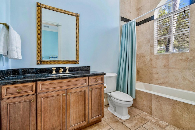 full bathroom featuring vanity, toilet, and shower / bath combo with shower curtain