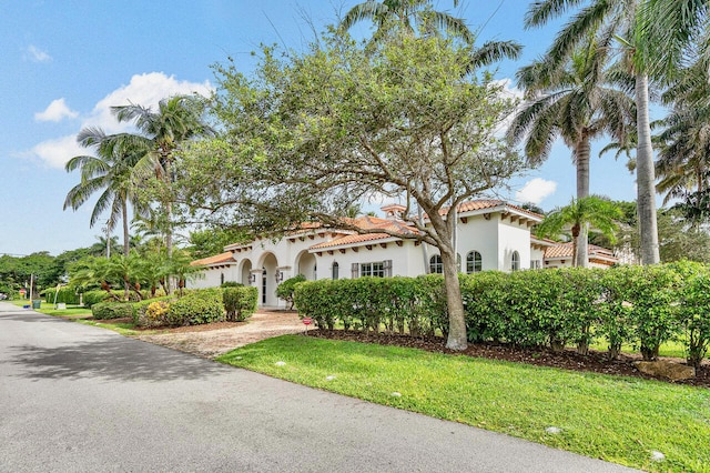 mediterranean / spanish house with a front lawn