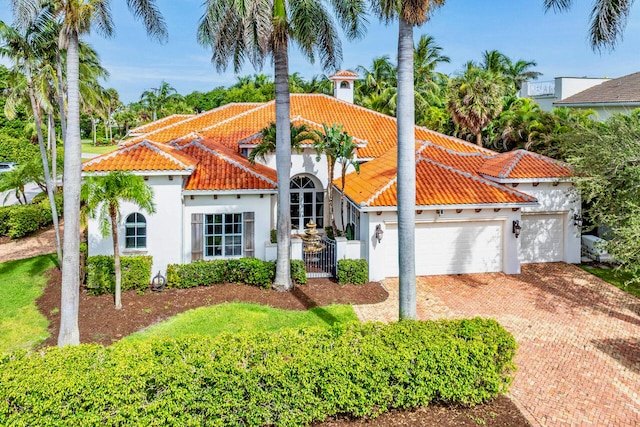 mediterranean / spanish home with a garage