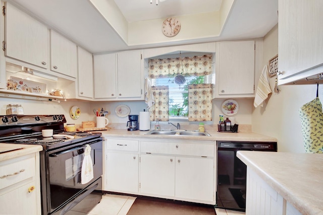 kitchen featuring light tile patterned floors, white cabinetry, sink, and black appliances