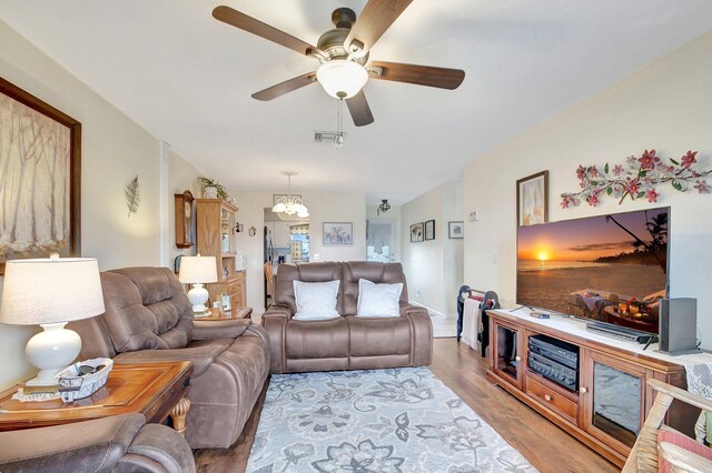 living room with ceiling fan and light wood-type flooring