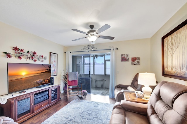 living room with ceiling fan and dark hardwood / wood-style flooring