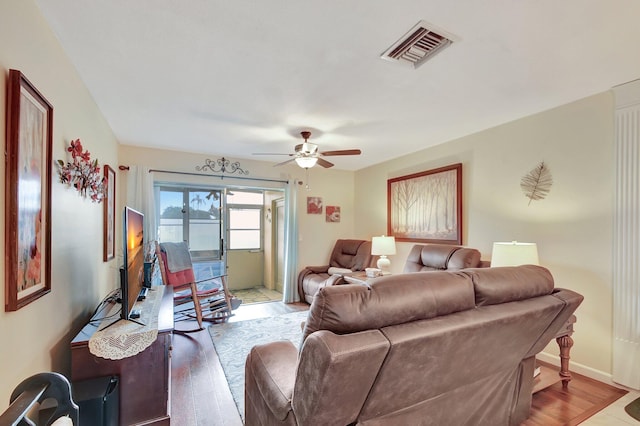 living room with ceiling fan and hardwood / wood-style floors