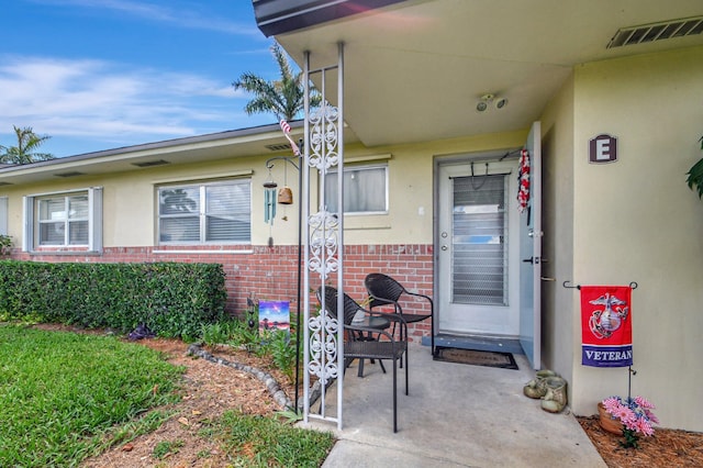 property entrance featuring a patio area