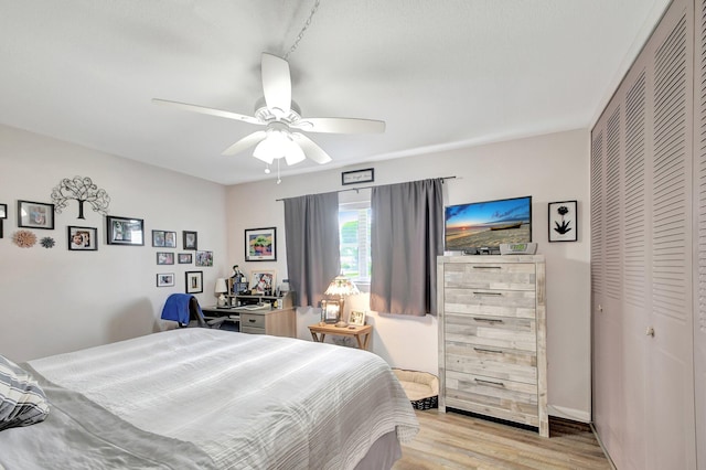 bedroom featuring ceiling fan, a closet, and light hardwood / wood-style flooring