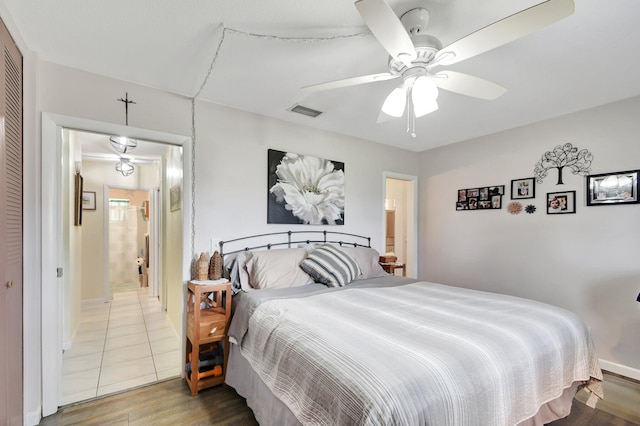 bedroom featuring ceiling fan, a closet, and hardwood / wood-style flooring