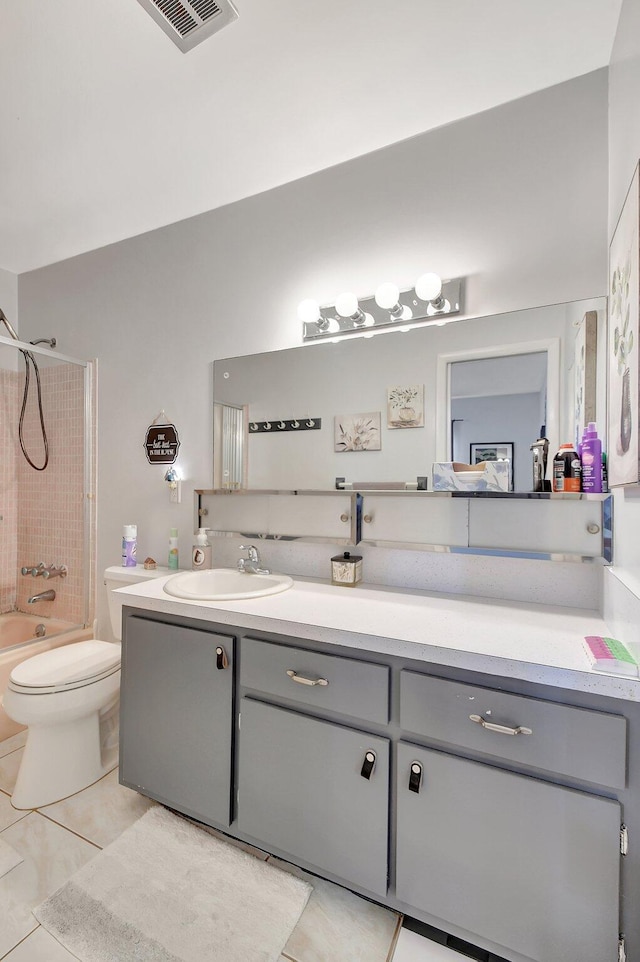 full bathroom with tile patterned floors, toilet, vanity, and tiled shower / bath