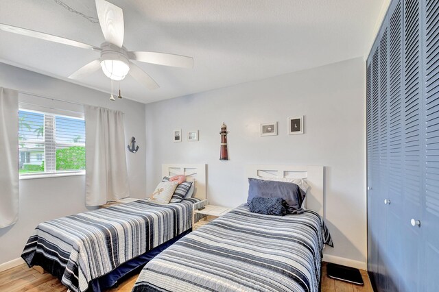 bedroom with light wood-type flooring and ceiling fan