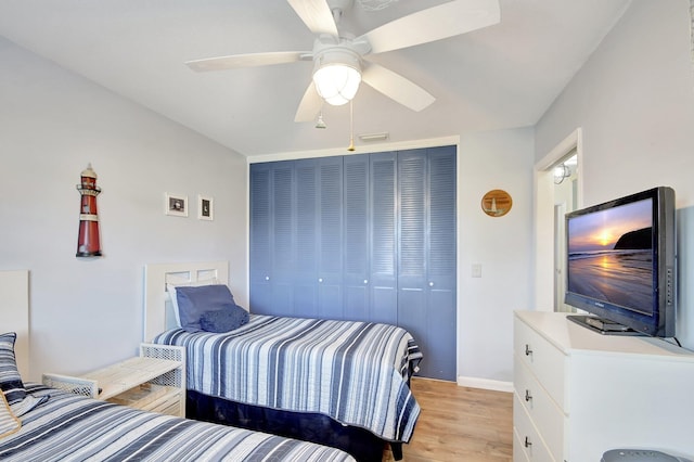 bedroom featuring ceiling fan, a closet, and light hardwood / wood-style floors