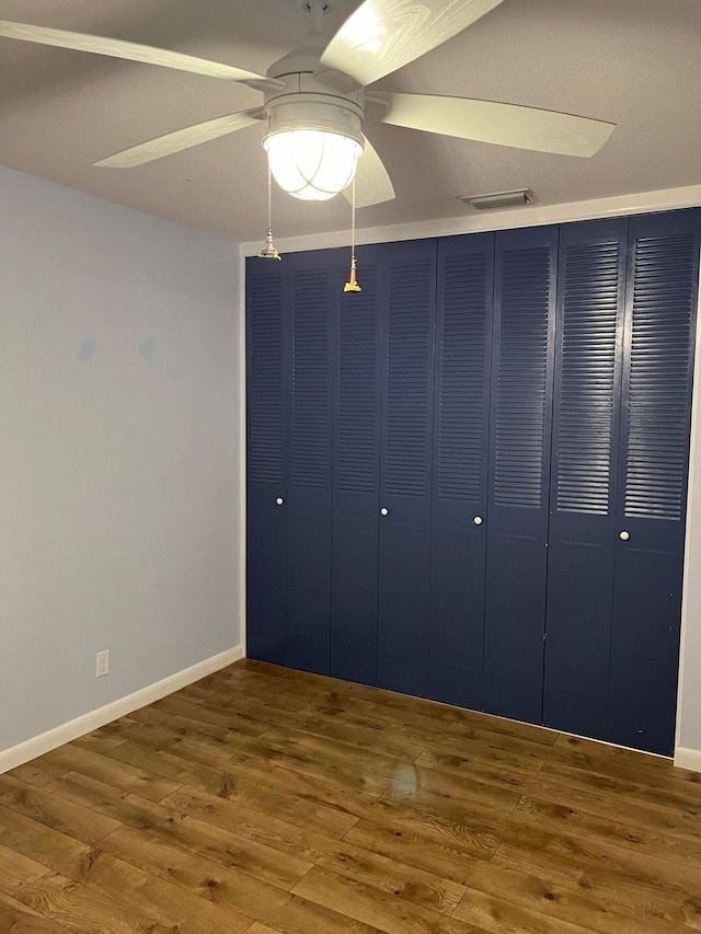 unfurnished bedroom featuring ceiling fan and hardwood / wood-style floors