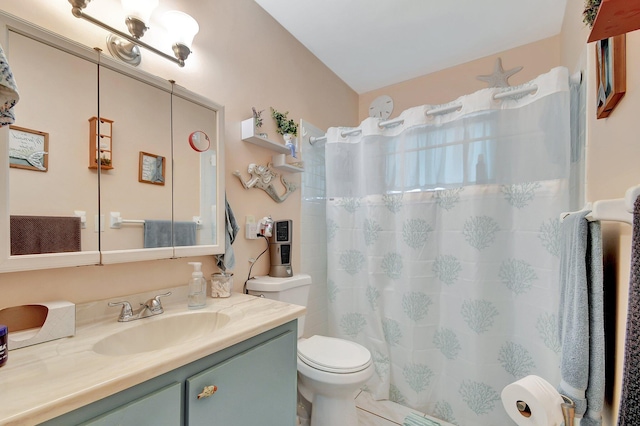 bathroom featuring toilet, tile patterned flooring, and vanity