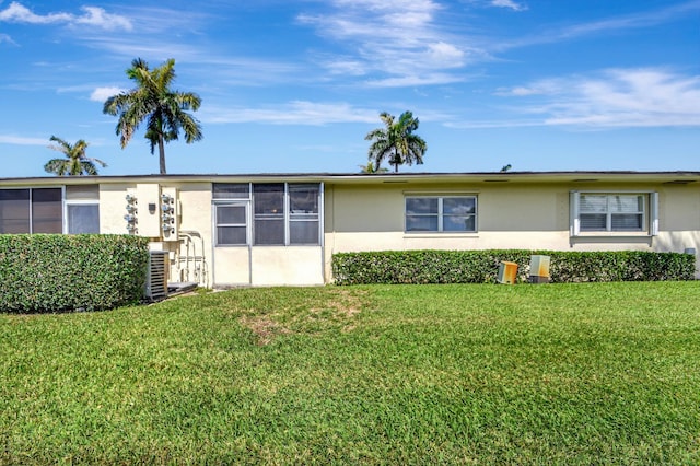 view of front facade with a front yard and cooling unit