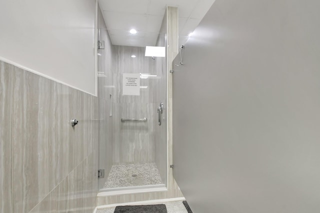 bathroom with a shower with door