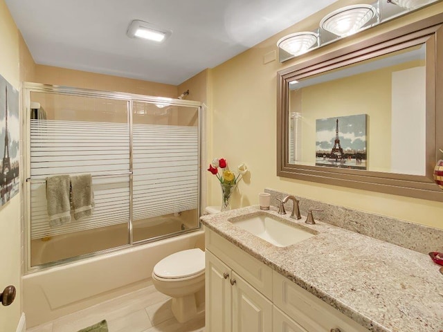 full bathroom featuring vanity, toilet, and combined bath / shower with glass door