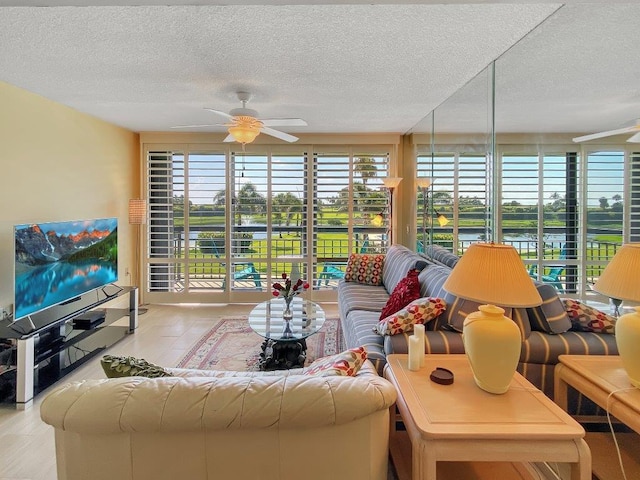 living room with a textured ceiling and ceiling fan