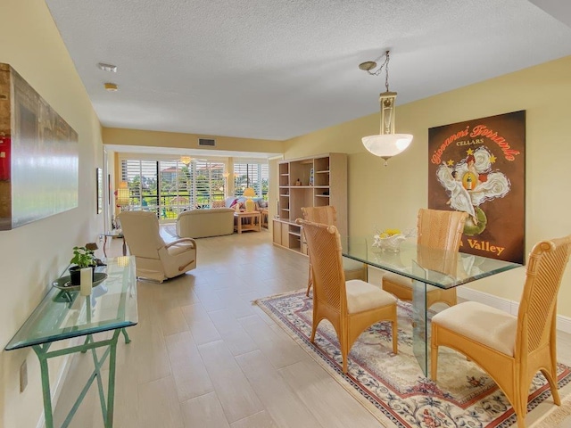 dining area with a textured ceiling