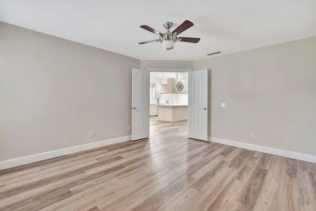 spare room featuring ceiling fan and light wood-type flooring