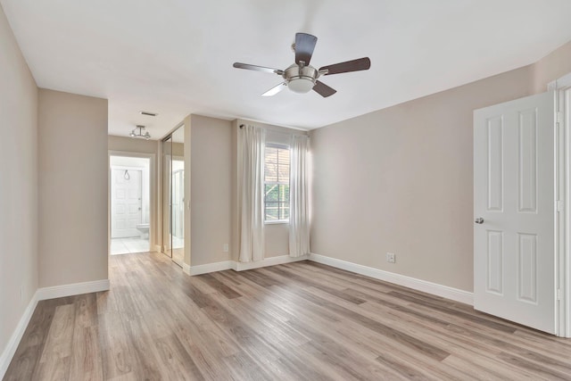 empty room featuring ceiling fan and light wood-type flooring