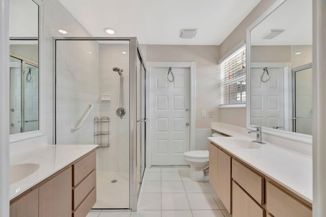 bathroom featuring vanity, tile patterned floors, and a shower with door