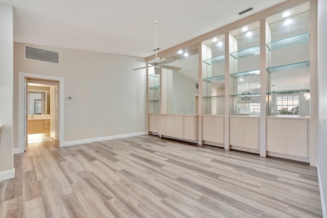 unfurnished dining area featuring ceiling fan, light hardwood / wood-style floors, and lofted ceiling