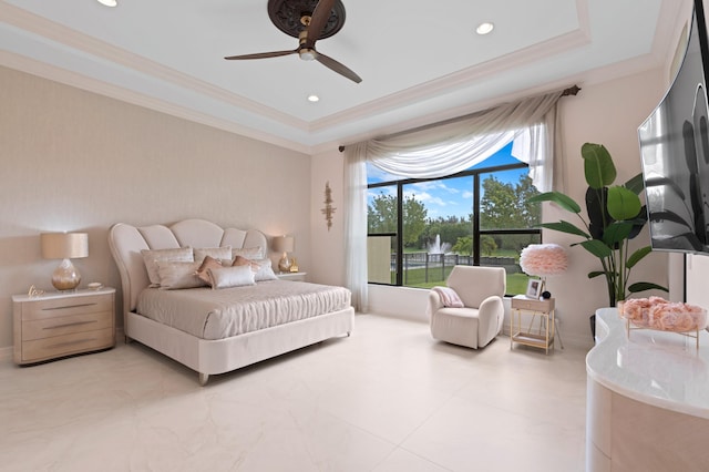 bedroom with a tray ceiling, ceiling fan, and crown molding