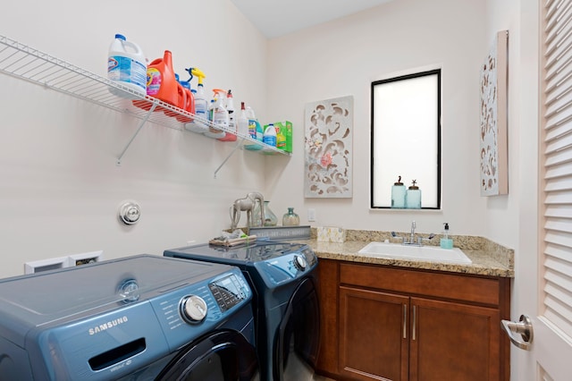 clothes washing area featuring separate washer and dryer and sink