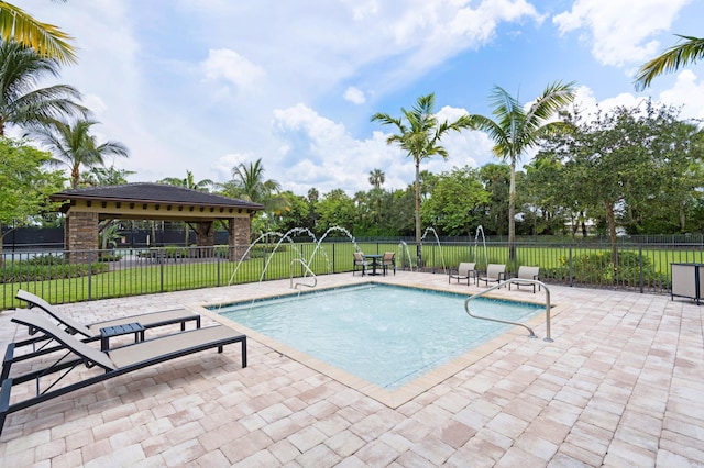 view of swimming pool with a gazebo, a patio area, and pool water feature