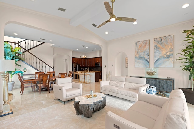 living room featuring ceiling fan, lofted ceiling with beams, and ornamental molding